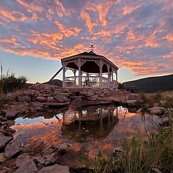 Beautiful sunrises and sunsets from gazebo with waterfall and fountain